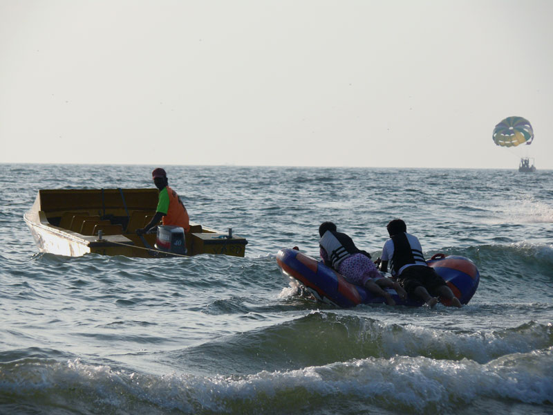 Two people on an inflated raft behind a boat, copyright Picturejockey : Navin Harish 2005-2009