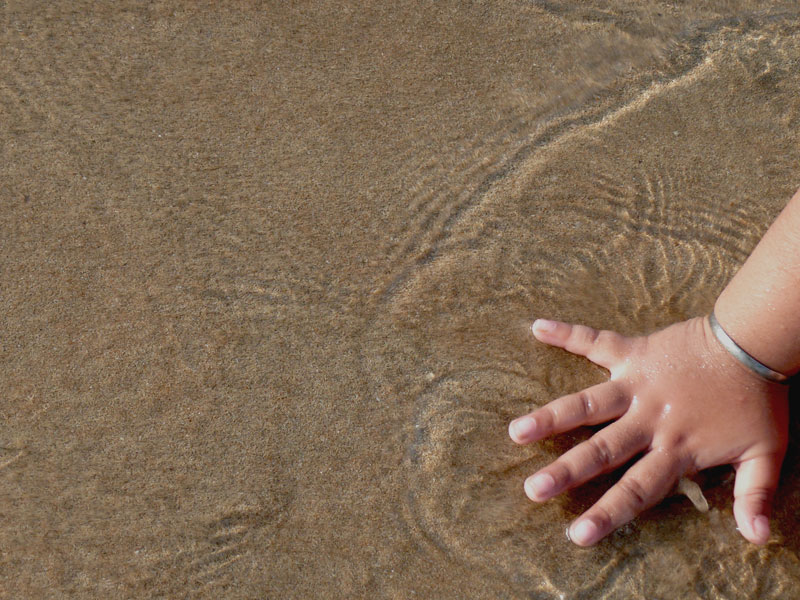 Manu's hand and water at Baga Beach, Goa, copyright Picturejockey : Navin Harish 2005-2009