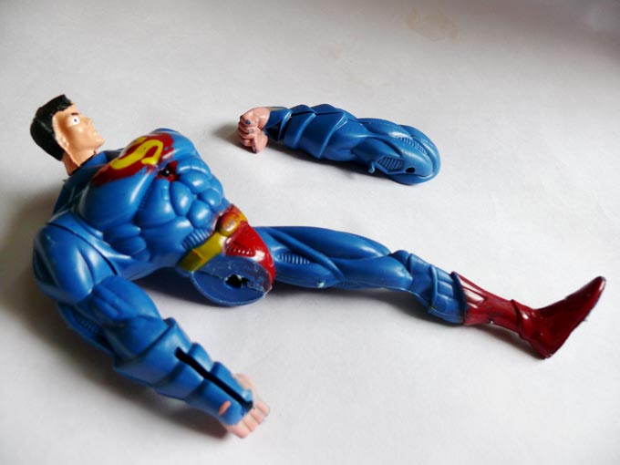 ...an arm... - An image of a broken superman toy with its arm next to it  | copyright Picturejockey : Navin Harish 2005-2007