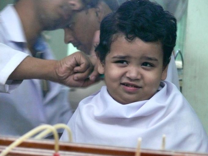 Are you sure you know what you are doing - An image of Manu getting his second haircut after his mundaun | copyright Picturejockey : Navin Harish 2005-2007