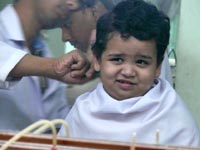 Are you sure you know what you are doing - An image of Manu getting his second haircut after his mundaun