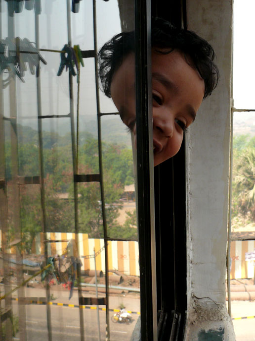 It's me...yet again - An image of Manu looking out of our bedroom window and his reflection | copyright Picturejockey : Navin Harish 2005-2008