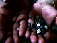 I'll make my own playground - An image of Manu's hands holding the pebbles he picked up from the playground