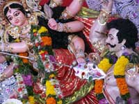 Happy Dussehra / Durga Puja / Bijoya Dashami - An image of an idol Durga killing Mahishasur at Durga Puja