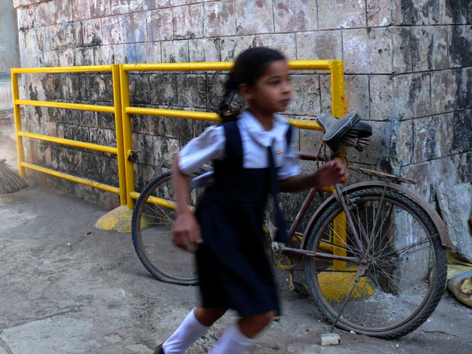 Girl and bicycle - An image of a girl running with a bicycle in the background  | copyright Picturejockey : Navin Harish 2005-2008
