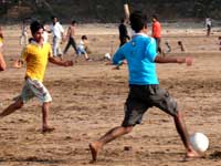 Beach soccer - An image of boys blaying football at Aksa beach, Madh, Mumbai