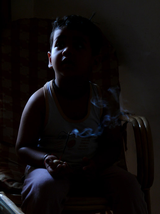 Manu and agarbatti - An image of Manu holding an incense stick  | copyright Picturejockey : Navin Harish 2005-2008