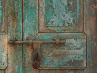 Under lock and key - An image of a rusted lock on a work out door at Kanheri Caves, Mumbai