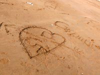 This message will self destruct in 5 seconds - An image of an arrow in a heart drawn in sand at Aksa beach, Madh, Mumbai