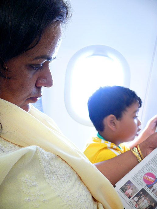 An absorbing read - An image of Mira and Manu on board the plane from Bombay to Delhi | copyright Picturejockey : Navin Harish 2005-2008