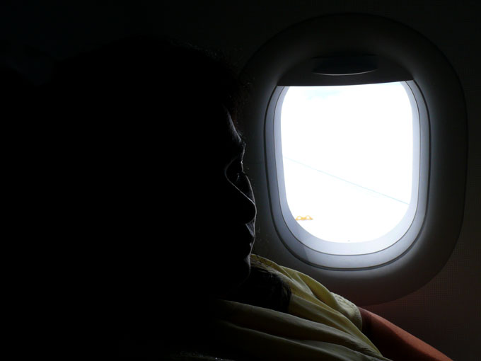 Window seat - An image of Mira in the plane on our way to Delhi from Bombay | copyright Picturejockey : Navin Harish 2005-2008