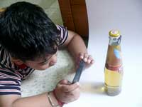 Poot ke paaon paalne mein... - Manu taking a picture of a bottle of Kingfisher Ultra Lager Beer