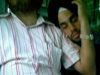 I'm still your baby - A young sardar boy sleeping on his father's shoulder on a Mumbai local train