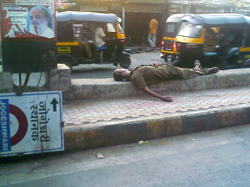 A drunk man sleeping on Western Express Highway  , copyright Picturejockey : Navin Harish 2005-2009