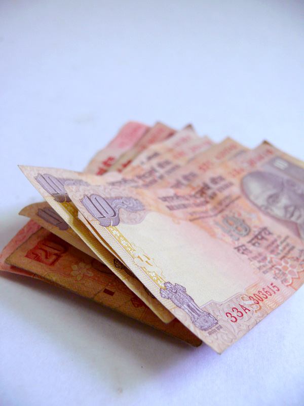 A bundle of ten and twenty rupees notes of Indian currency, copyright Picturejockey : Navin Harish 2005-2009