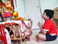 Ganpati going to his mommy - Manu sitting in front of the Ganesha idol at out home