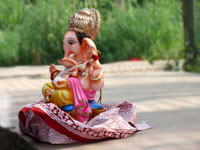 Waiting for his turn - A statue of Ganpati by Yamuna river